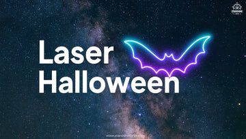 Halloween laser lights liquid sky over villa façade with purple beams