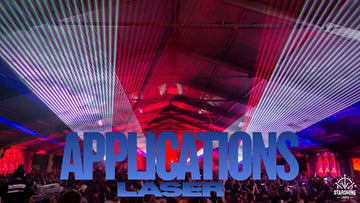 Outdoor laser light show over city landmark at night