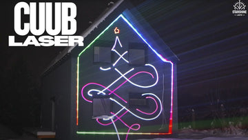 House facade lit up with LaserCube christmas laser lights
