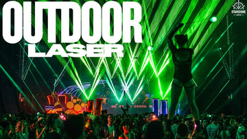 Outdoor laser light show over city skyline