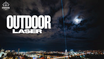 Outdoor laser light show projector creating skyline beams at night