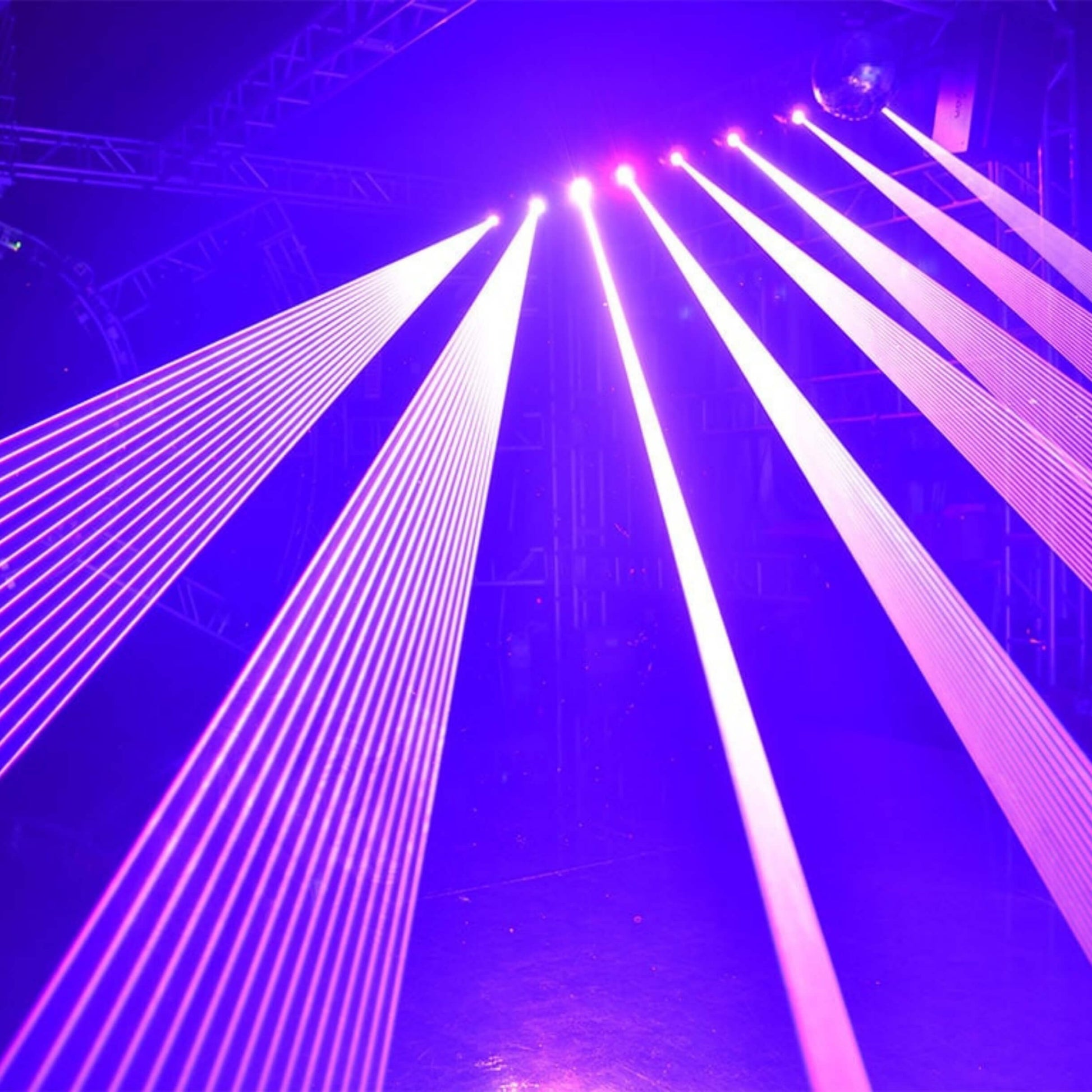 Strong blue laser triangles cutting through haze in club