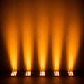 Outdoor stage lighting beside a swimming pool